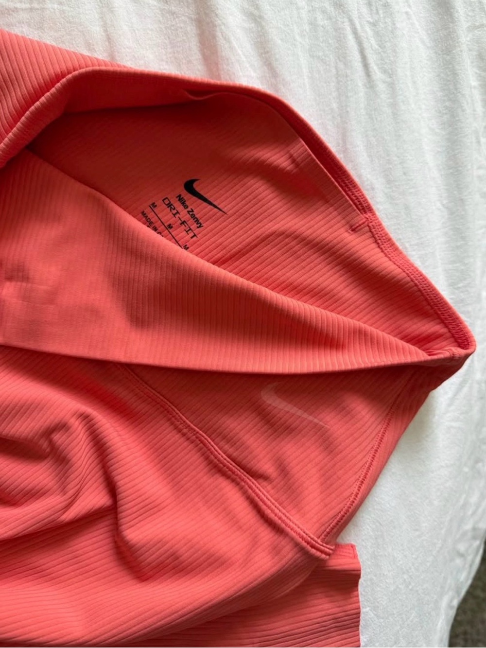 Nike Women’s Dri-FIT Ribbed leggings in Coral Pink